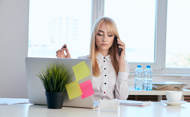 beautiful business woman in the office at the desk