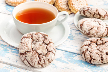 Cup of tea with cookies on the old wooden background.
