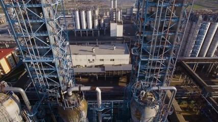 Two huge towers distillation pipes and tanks at the refinery. Aerial view