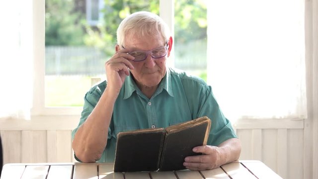 Old Man Reading A Book. Elderly Male In Glasses. Most Interesting Novel.