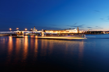 Fototapeta na wymiar Night cityscape with river and bridge in Saint-Petersburg. Lantern lights on the bridge