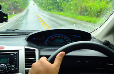 man driving car from rear view on the highway with raining