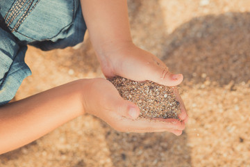 child hands closeup. from hand pours sand lifestyle contact pedigree ancestry