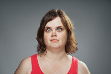 surprised woman in a red tank top, emo...