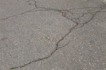 Texture with cracks on asphalt background