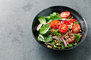 Buckwheat salad with cherry tomatoes and baby spinach