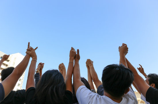 Community Initiative Or Team Concept, Hands Of Group Of People In The Blue Sky