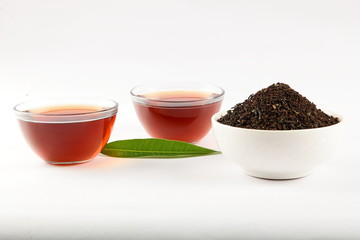 Fresh tea cups with heap of leaf tea dust