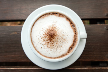 Fototapeta premium hot cocoa and milk foam on wooden table