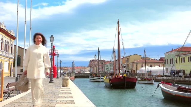timelapse of woman walking in sea village in Italy