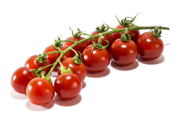 Mature cherry tomatoes o a white background.