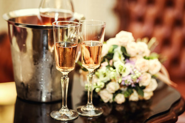 wedding decoration with two glasses of champagne on ceremony,wedding bouquet and two glasses with champagne