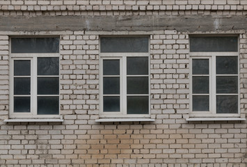 Fototapeta na wymiar A dirty window in a brick wall.