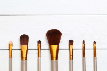 Make up brushes on wooden white desk
