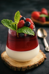 Italian dessert - panna cotta with berries and berry jelly.