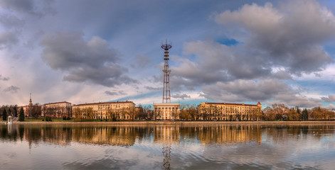 Fototapeta na wymiar Minsk, Capital City of Belarus. Panoramic Autumn View Of The River Svisloch Embankment, Minsk Television Center With Minsk TV Tower From The Side Of The Park Named After Yanka Kupala.