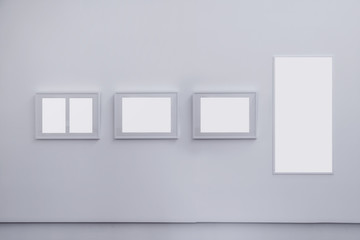 Four blank grey frame on grey wall, decoration idea