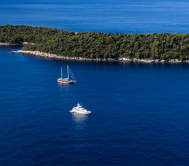 Sailboat and yatch beside Lokrum island in Dubrovnik Mediterranean coast, Croatia