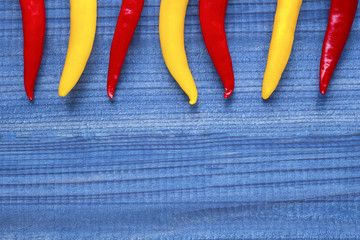 cayenne chilli peppers on wooden background