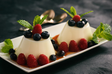 Italian dessert - panna cotta with berries and caramel sauce.