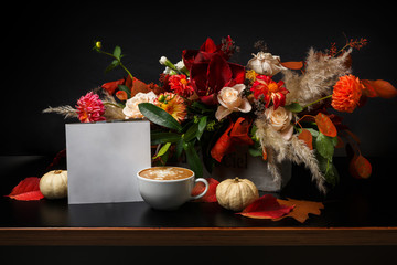 Cappuccino coffee and flowers composition on black background