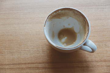 The coffee in the white cup was drunk. Empty of coffee in the white cup.