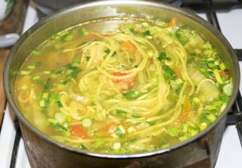 Cauldron of yellow chicken soup