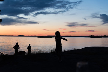 Kids playin in the sunset near water