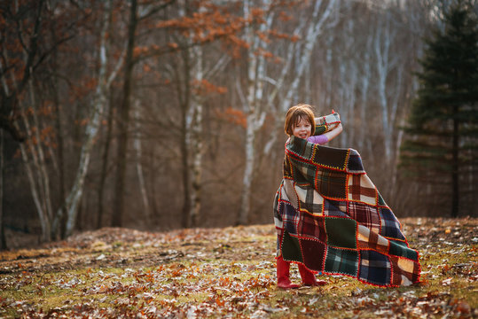 Girl wrapped in a blanket spinning around