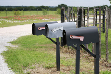 Three old mail boxes at farm country road  