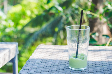 glass of green tea frappe or green tea ice shake after finished drinking.