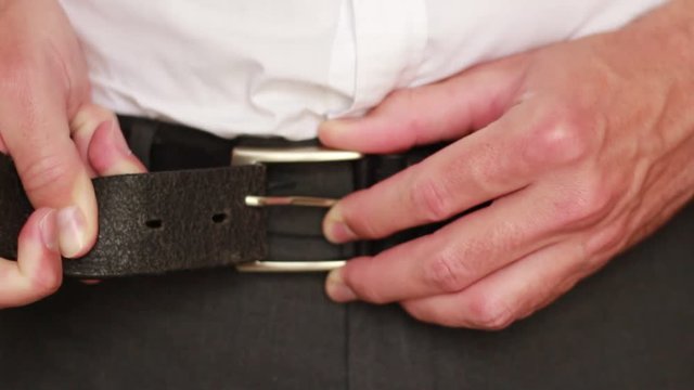 Trying to button a belt