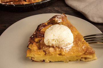 Slice of apple pie with icecream cone on blurred background