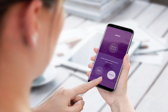 Sending Email From Mobile Phone. Modern Smart Phone In Woman Hand. View Behind The Shoulder.
