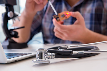 High precision engineering with man working with microscope