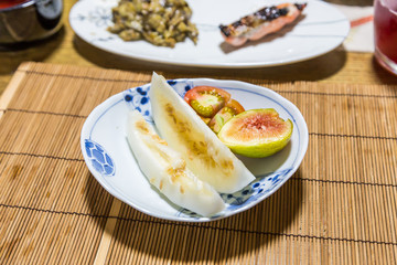 Fresh fruits after breakfast - honeydew melon, fig and tomato.