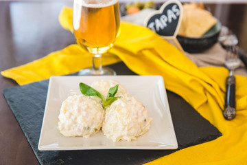  Spanish Tapas. Russian salad in a white plate. Ensaladilla rusa.