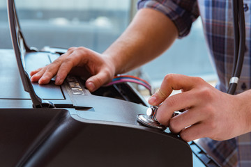 Repairman repairing broken color printer