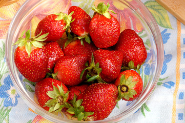Fresh strawberry in a transparent salad bowl