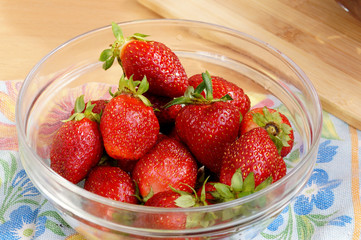 Fresh strawberry in a transparent salad bowl
