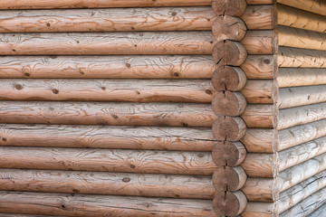Wooden house from calibrated logs of brown color