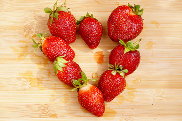 Strawberry in the form of heart on a chopping board