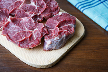 Fresh raw beef on wooden cutting plate