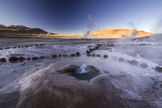 geyser tatio with water surface at sunrise