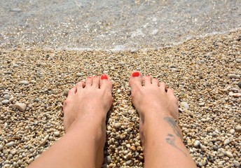  beautiful woman legs on the beach