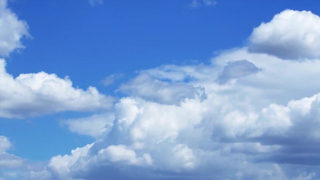 Time lapse video of white clouds on a blue sky.