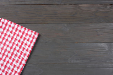 red cloth on dark wooden background with copy space. Top view.