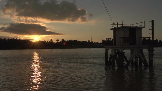 Pathein, sunset at the Irrawaddy river with small fishing boats