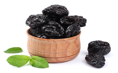 Dried plums - prunes in wooden bowl isolated on white background