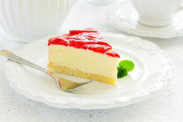 Delicious strawberry cheesecake on a white background.